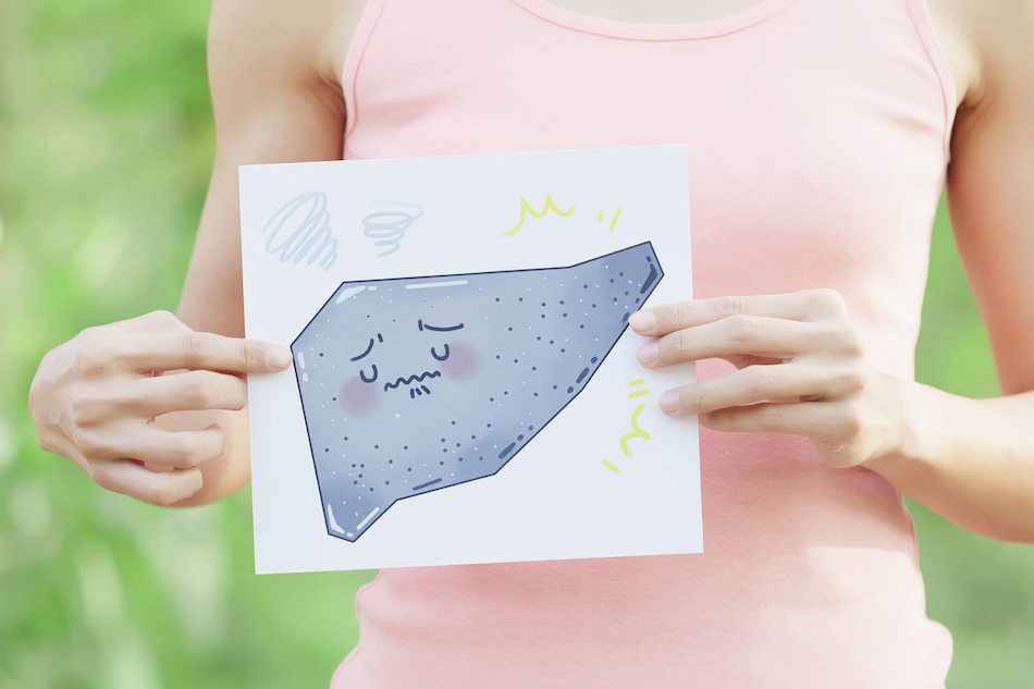 woman holding drawing of sad liver